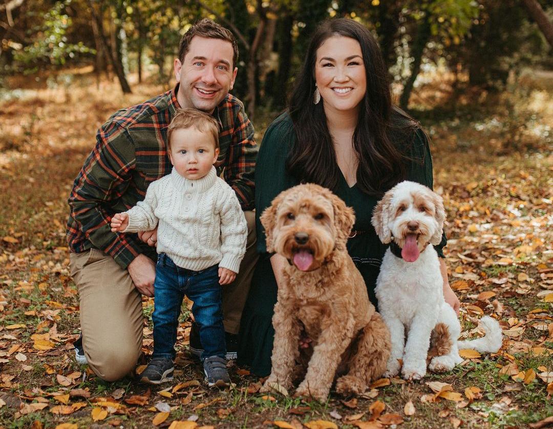 Two Australian Labradoodles, their humans and their baby brother